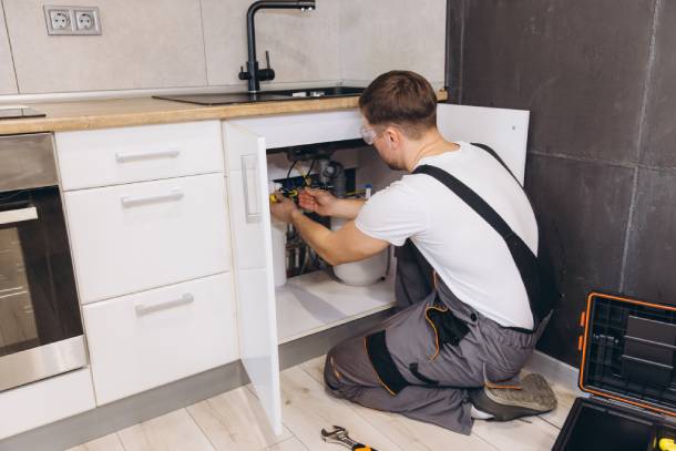 Plumber fixing sink